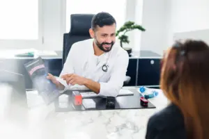 Ein Pneumologe im vertrauensvollen Beratungsgespräch mit einer Patientin im Sprechzimmer des LungenZentrums Hirslanden Zürich